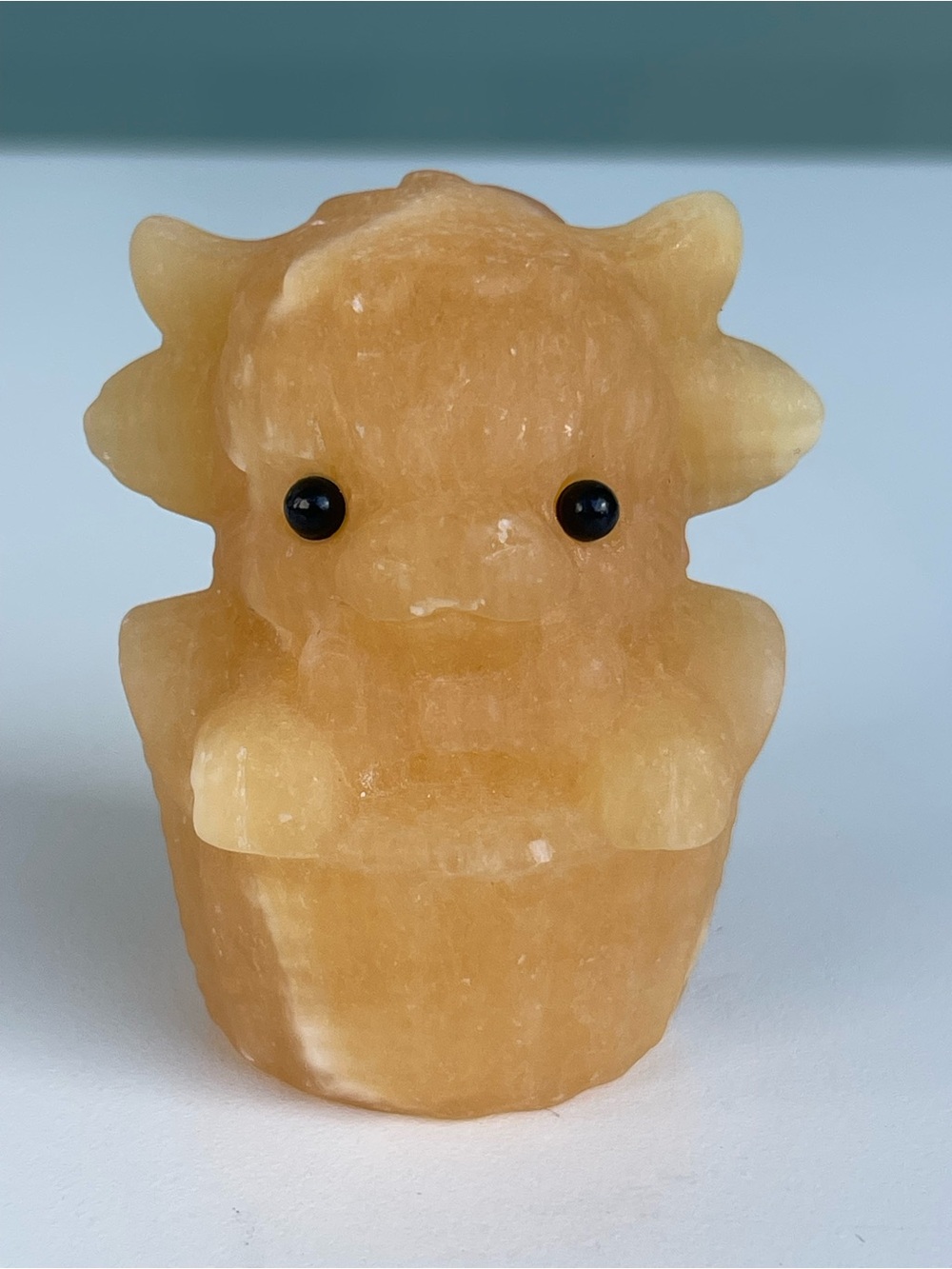 Honey Calcite Baby Highland Cow in Basket Carving
